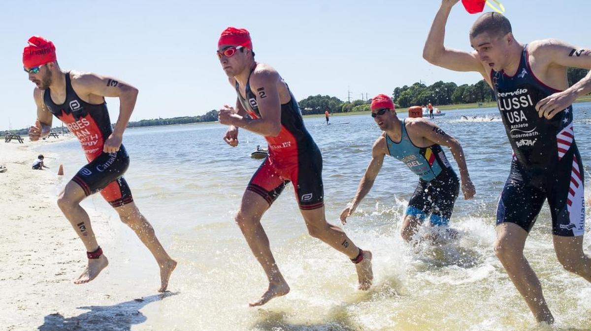 Men’s Elite race competitors leave the water and rush toward the cycling portion of the Bradenton-Sarasota CAMTRI Sprint Triathlon Championships on Saturday afternoon at Nathan Benderson Park in Sarasota.