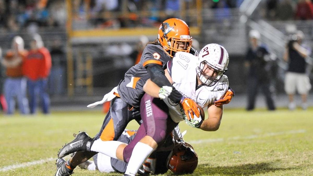 Ryan Neuzil hauls in a pass and drives for the end zone for Braden River during a Nov. 27, 2015, game.