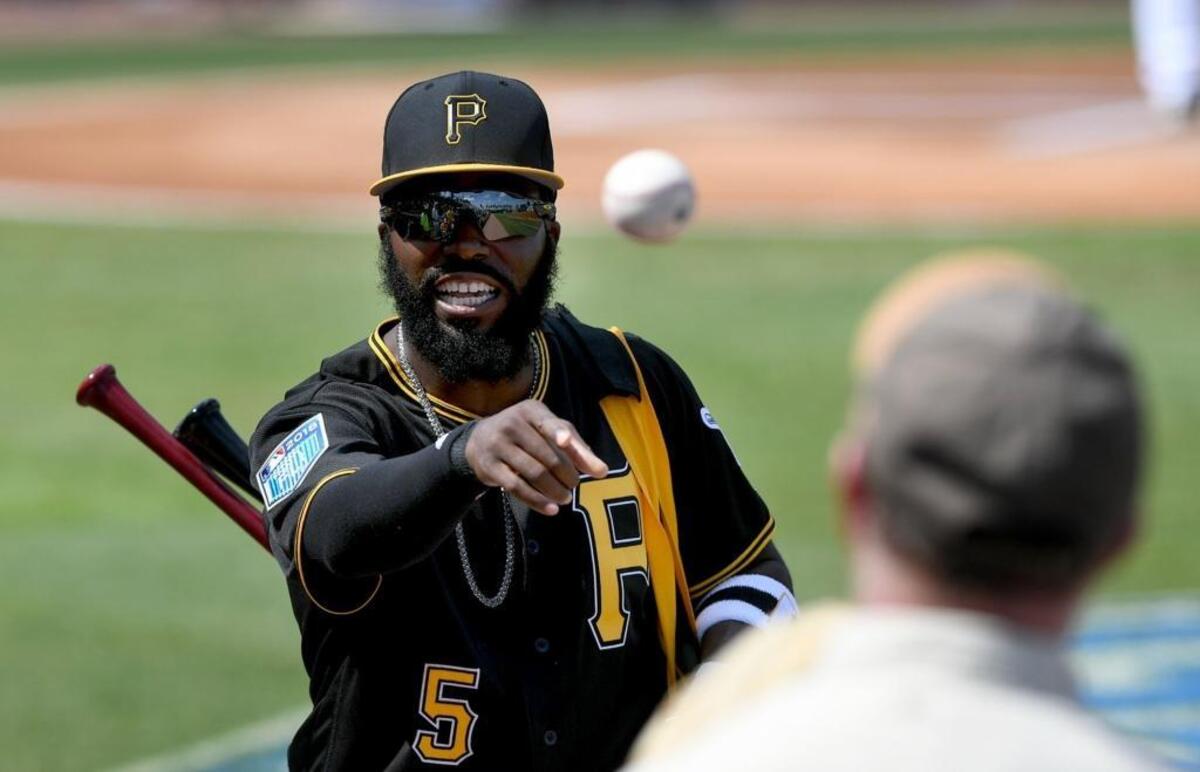 Pittsburgh Pirates infielder Josh Harrison tosses a ball to a fan during Thursday’s game against the Toronto Blue Jays at LECOM Park in Bradenton.