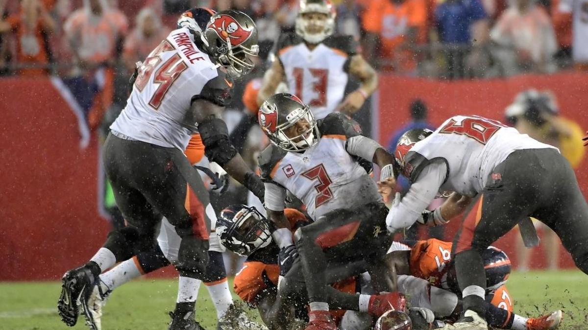 Tampa Bay Buccaneers quarterback Jameis Winston (3) lands on a pile after having his pass knocked down by Denver Broncos defensive tackle Billy Winn (97) as outside linebacker Shaquil Barrett (48) watches during the second half in Tampa on Sunday.
