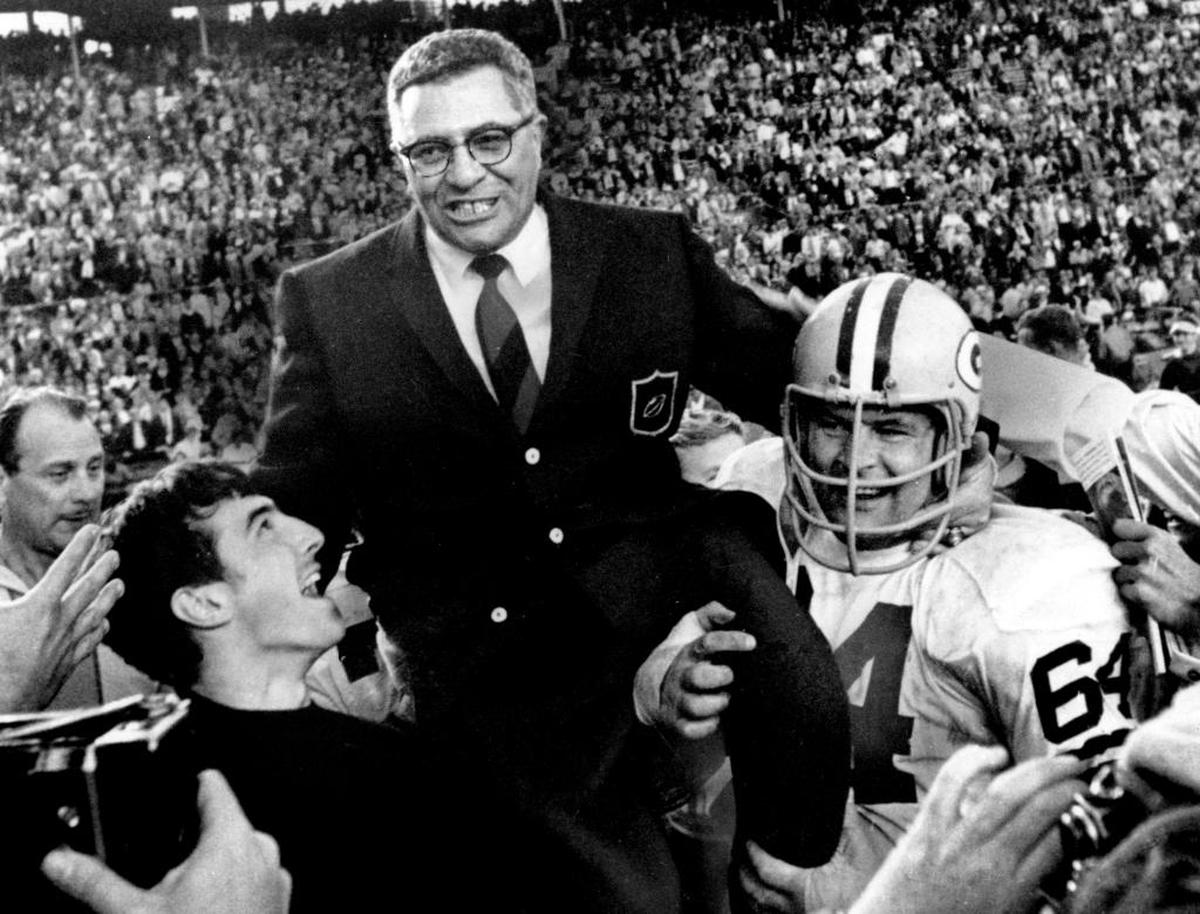 Vince Lombardi is carried off the field by several players, including Jerry Kramer (64) after his last game coaching Green Bay, a 33-14 win in Super Bowl II at the Orange Bowl.