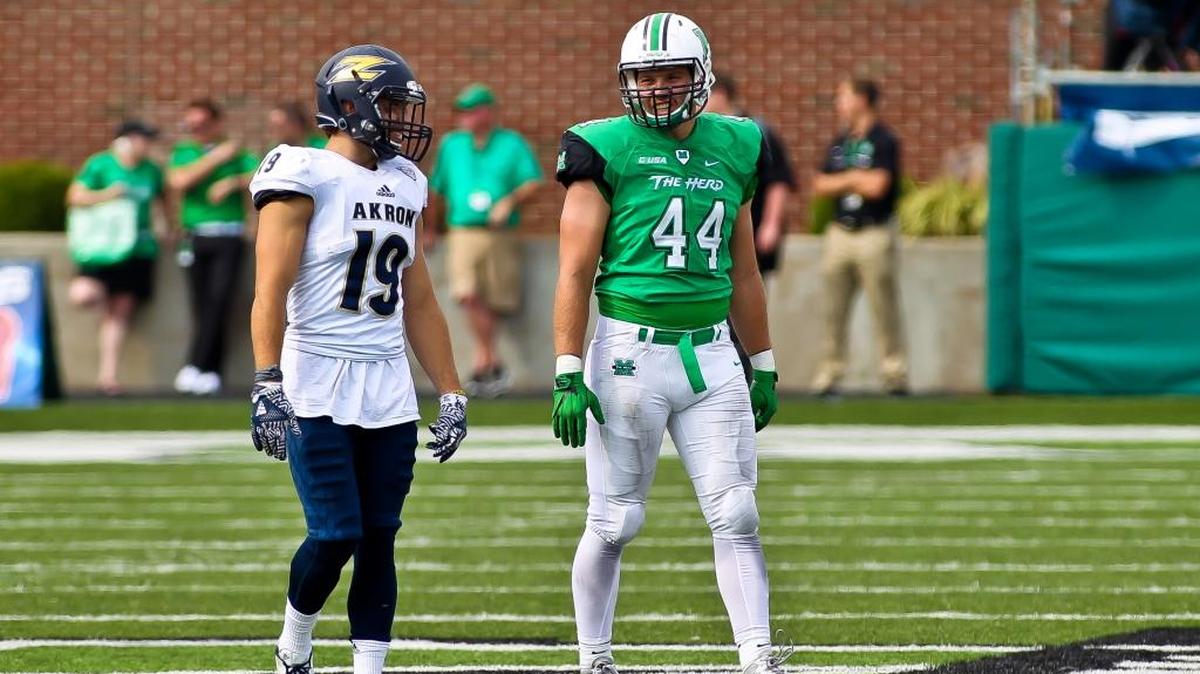 Marshall’s Blake Keller, right, will play his final college football game on Saturday at the New Mexico Bowl. He’s seen here talking to Akron’s Anthony Lauro, a former teammate at Manatee High, during a 2016 game.