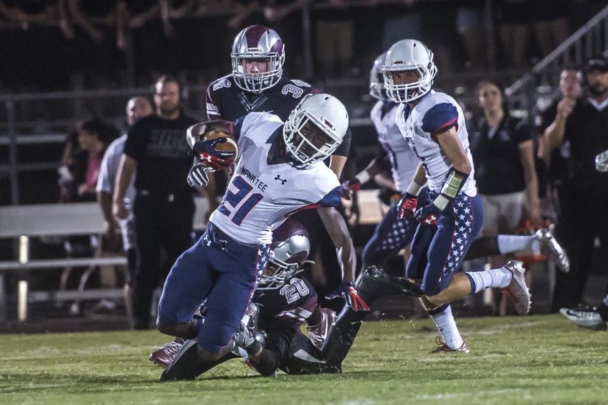 Manatee’s Cedrick Waters is brought down by Riverview’s Jared Wynter.