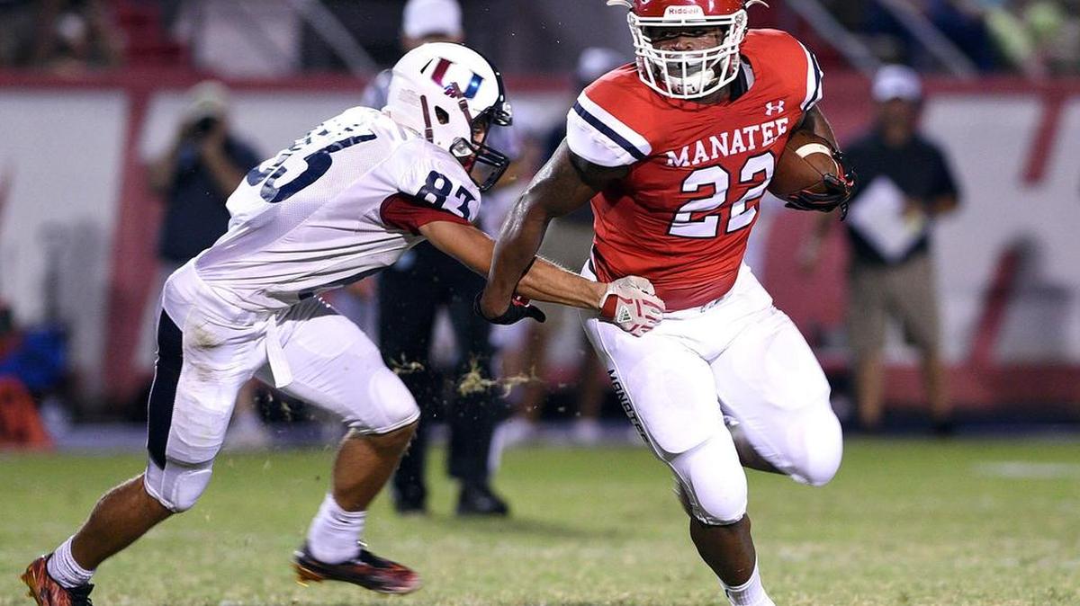 Manatee’s Josh Booker eludes Palm Harbor’s Lucas Gelep during Friday night’s homecoming game in Bradenton.
