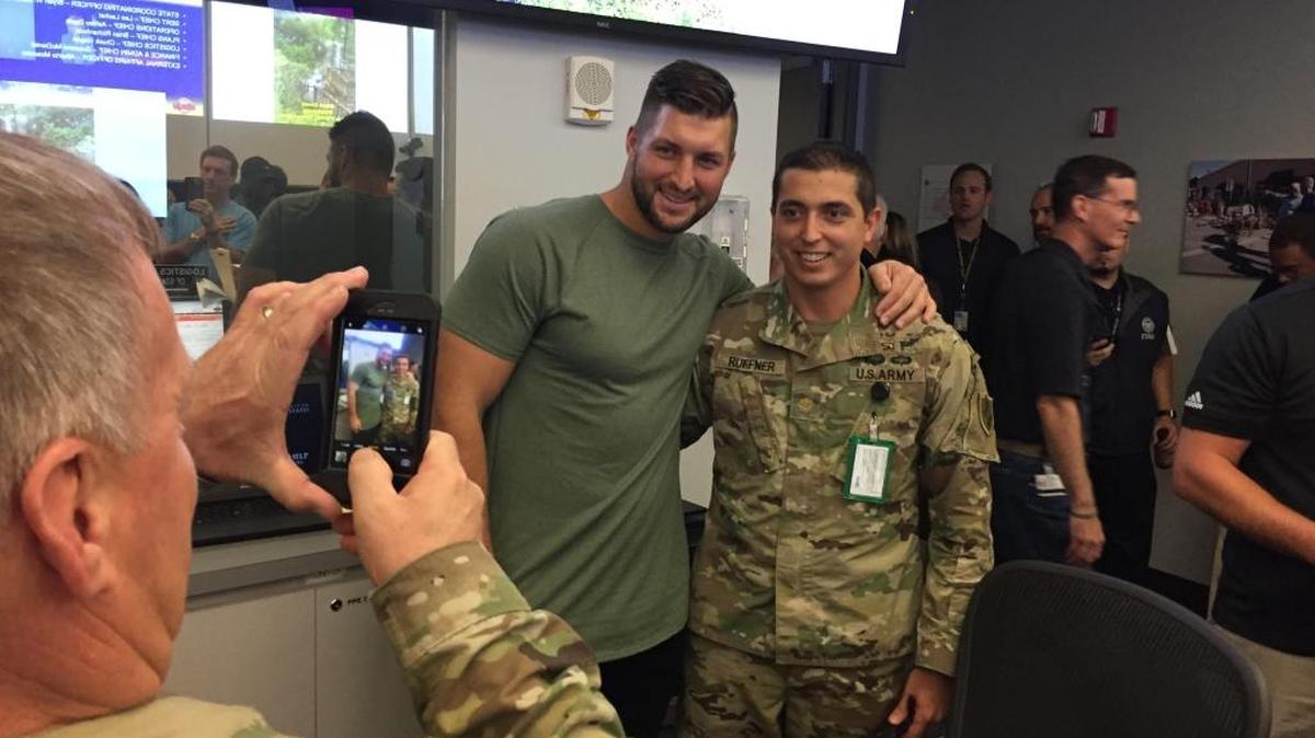 Former NFL quarterback Tim Tebow, of Jacksonville, takes a photo with a National Guardsman during a visit to the state Emergency Operations Center in Tallahassee on Sept. 12, 2017. Tebow visited with Gov. Rick Scott to thank the state workers for their preparation and response efforts to Hurricane Irma.