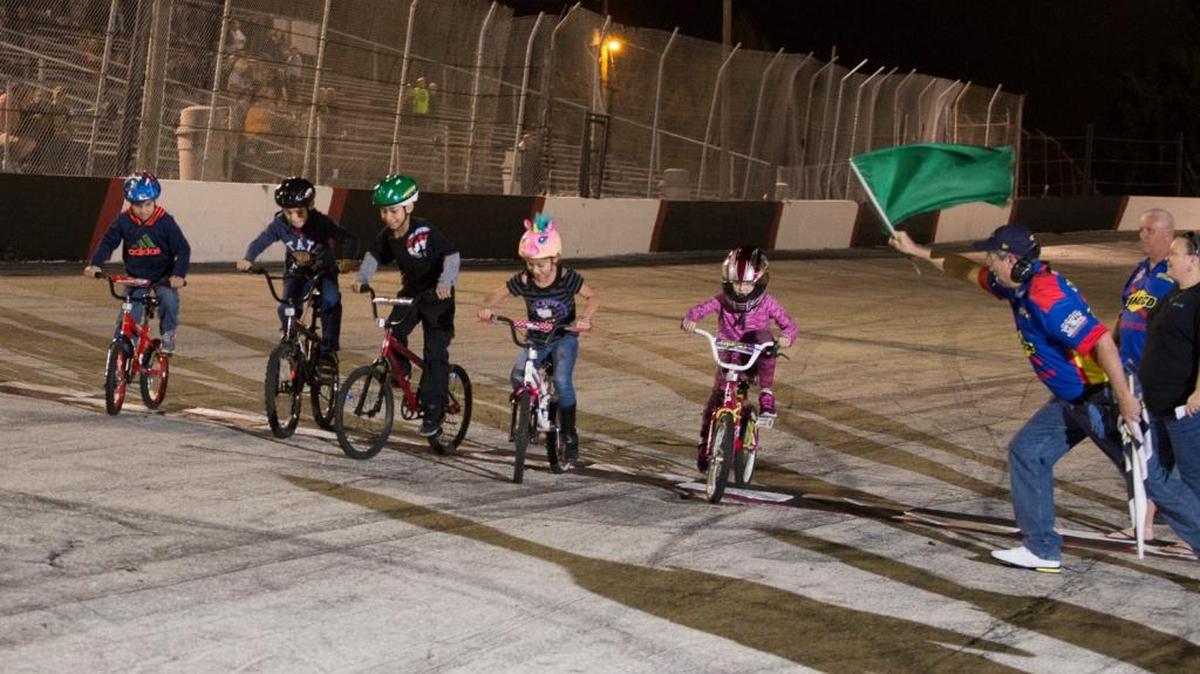 Participants in the bicycle race line up at the start at Desoto Speedway on Saturday evening.