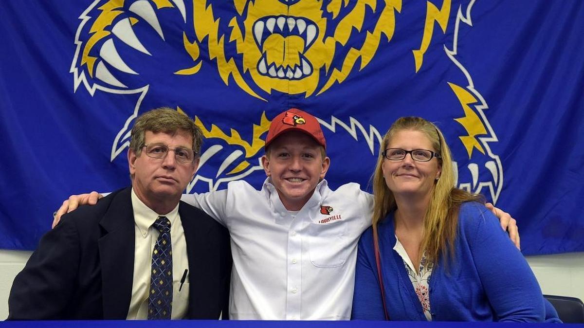 Bayshore High swimmer T.C. Smith with parents Mike Smith and DeAnna Ross at a signing ceremony. Smith signed to swim with Louisville. Smith was the top qualifier in the Class 2A state swim meet preliminaries in both the boys 200 and 500 freestyle events on Saturday morning.
