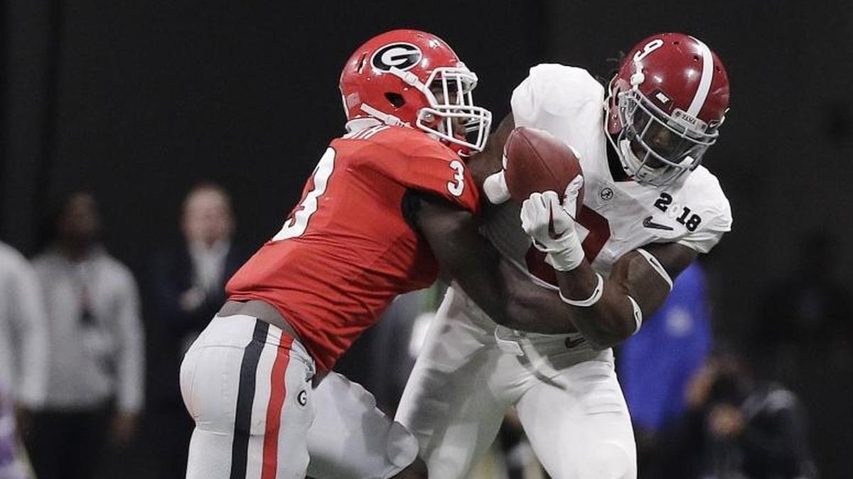 Alabama's Bo Scarbrough catches a pass in front of Georgia's Roquan Smiths during the second half of the NCAA college football playoff championship game Monday, Jan. 8, 2018, in Atlanta.