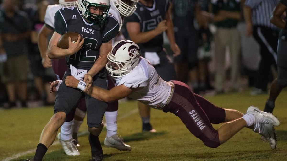 Braden River's Matthew Haftke dives at Venice's Bryce Carpenter during Braden River High School's game at Venice High School on Friday, October 14, 2016 in Venice.