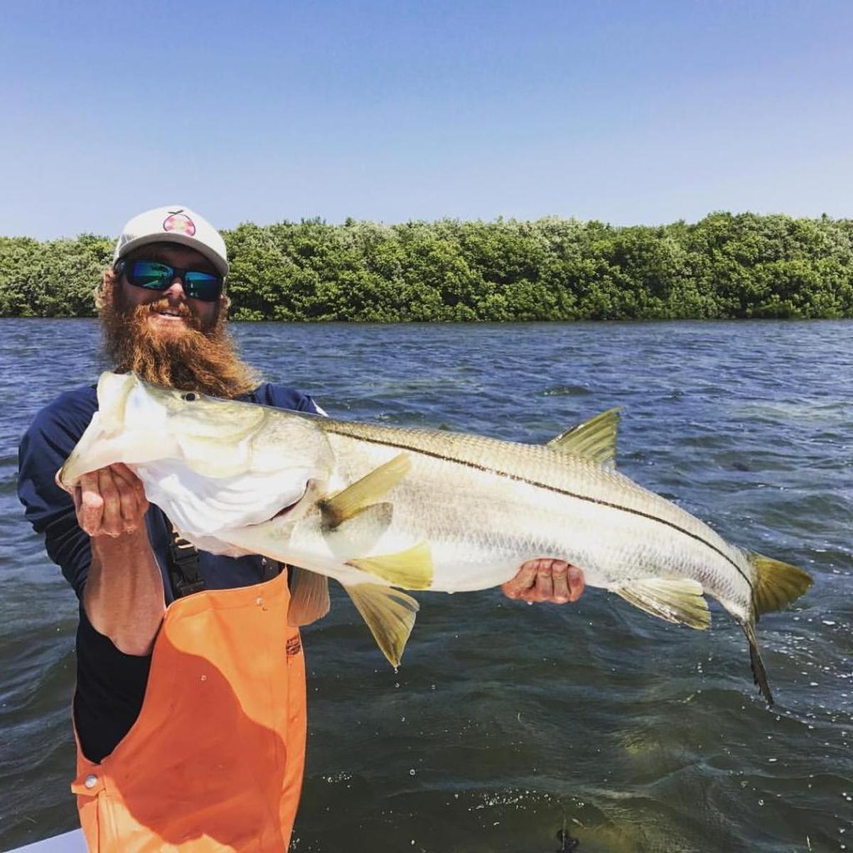 Capt. Will Osborne holds the 44 1/2 snook caught in Sarasota Bay on Monday, April 3. the fish was caught while braving windy conditions.
