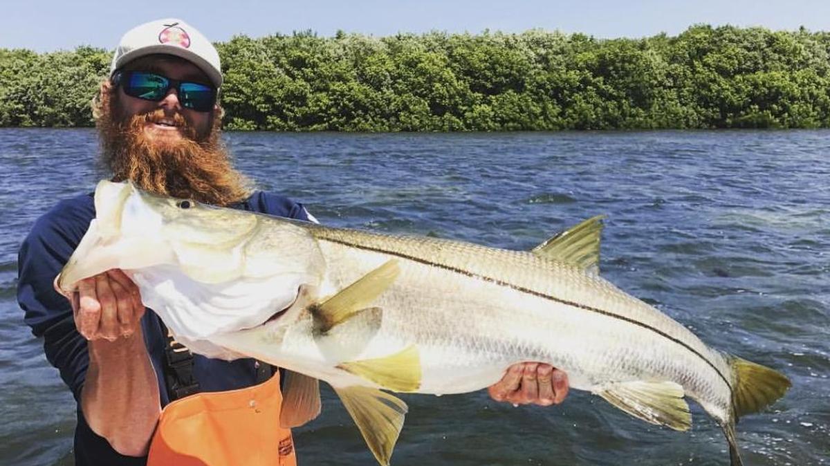 Capt. Will Osborne holds the 44 1/2 snook caught in Sarasota Bay on Monday, April 3. the fish was caught while braving windy conditions.