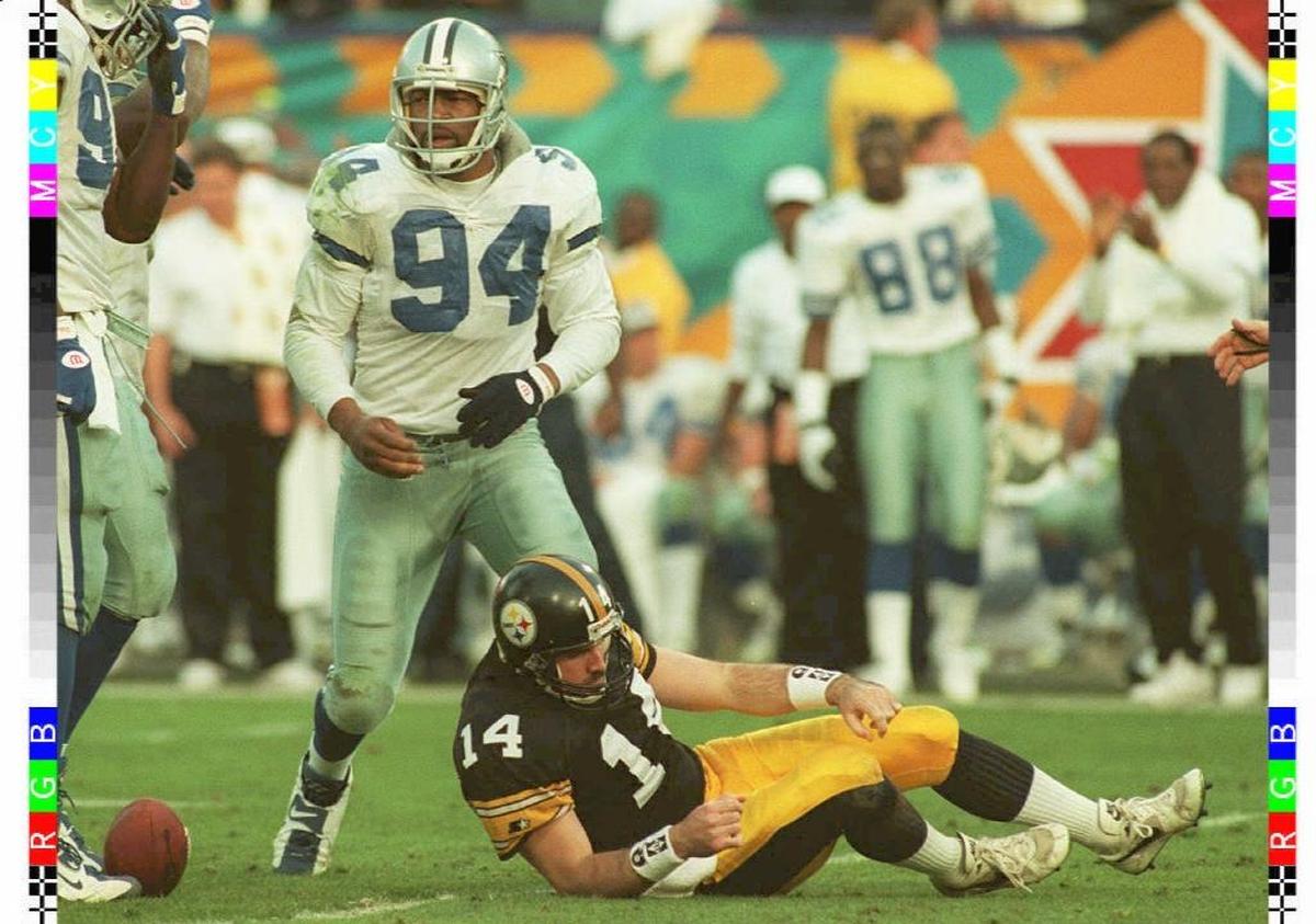 Dallas defensive end Charles Haley stands over Pittsburgh quarterback Neil O’Donnell after sacking him during Super Bowl XXX.
