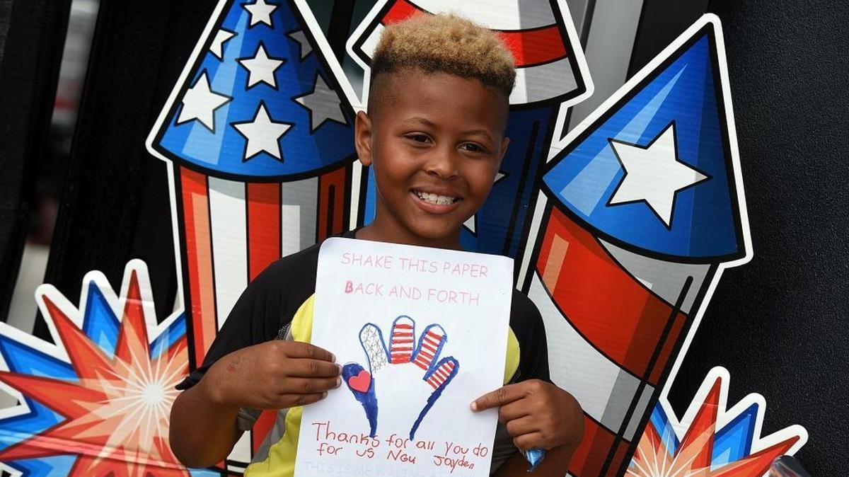 Jayden Wade, 8, holds up his drawing for the troops as the Marauders host Manasota Operation Troop Support's monthly care package for the troops' packing party at McKechnie Field in Bradenton. Saturday the Marauders celebrated Military Appreciation day.