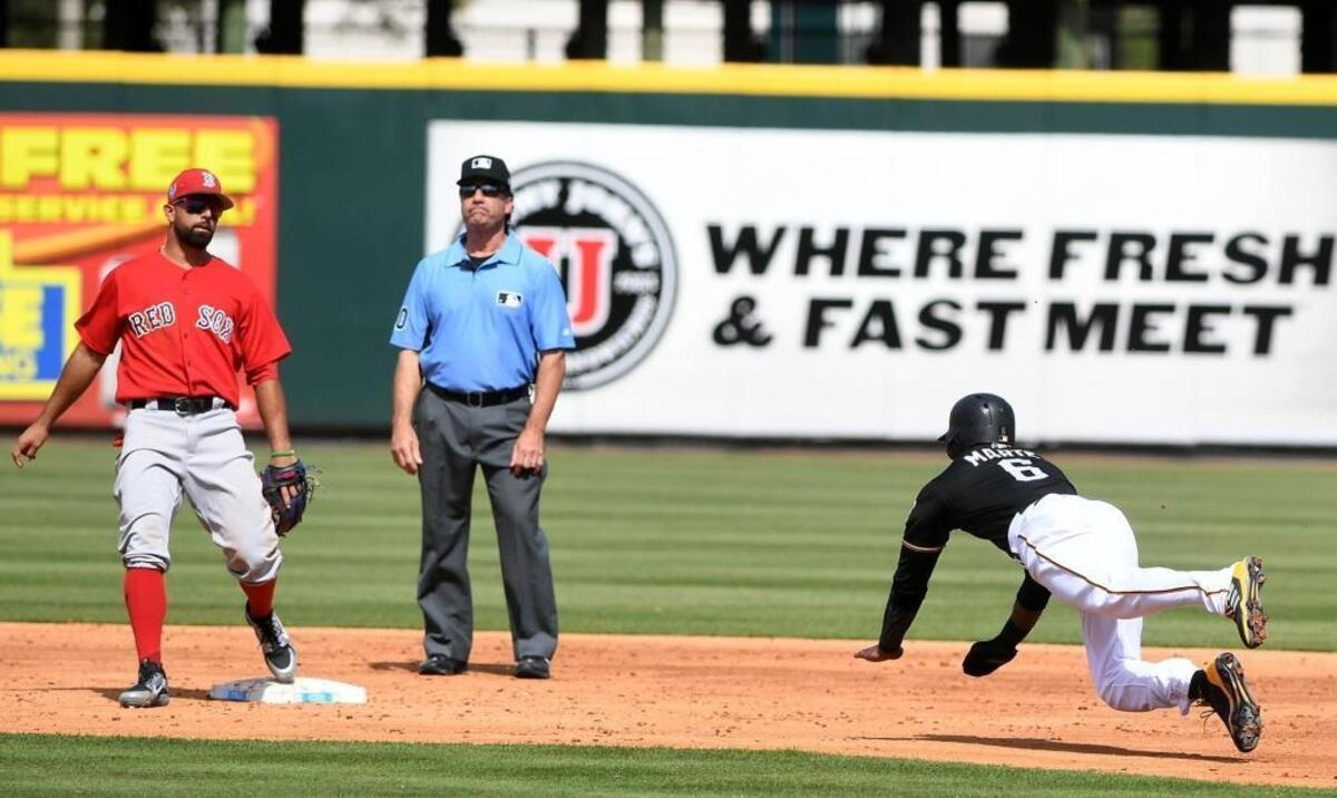 The Pirates’ Starling Marte, who had two hits in three at-bats, steals second base against the Red Sox on Monday at LECOM Park.