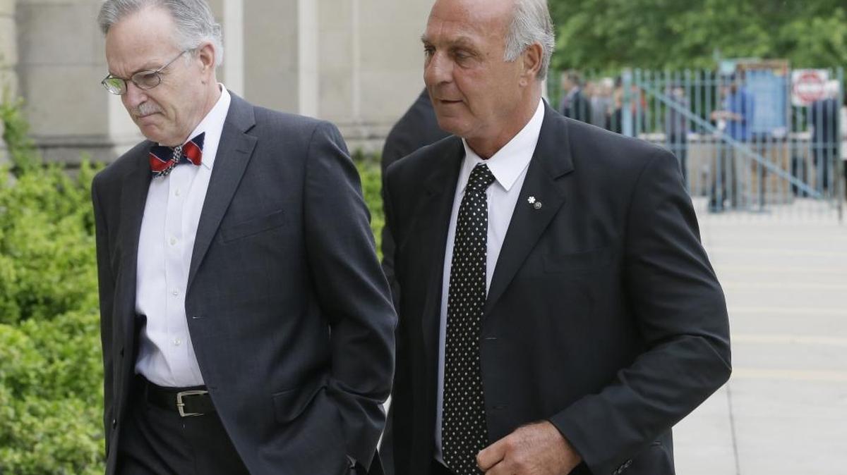 Hockey Hall of Famer Guy Lafleur, right, arrives at the Cathedral of the Most Blessed Sacrament for the funeral of Gordie Howe, Wednesday in Detroit.