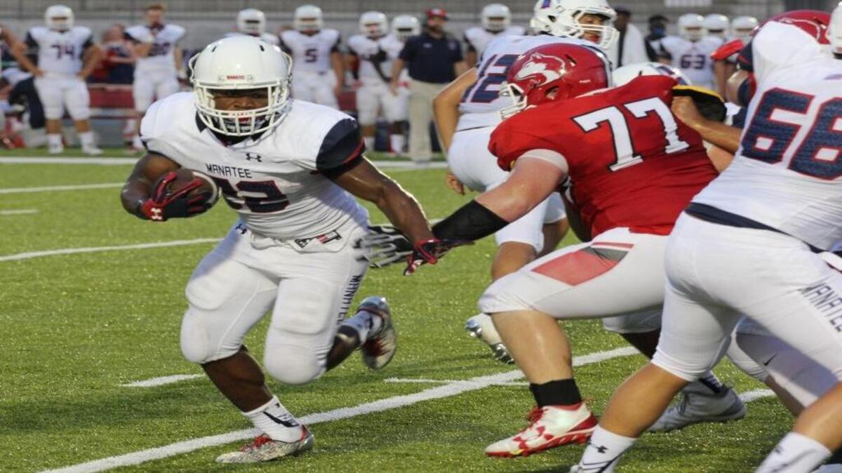 Josh Booker looks to break outside on a run in the first half of Friday’s game in Alabama.