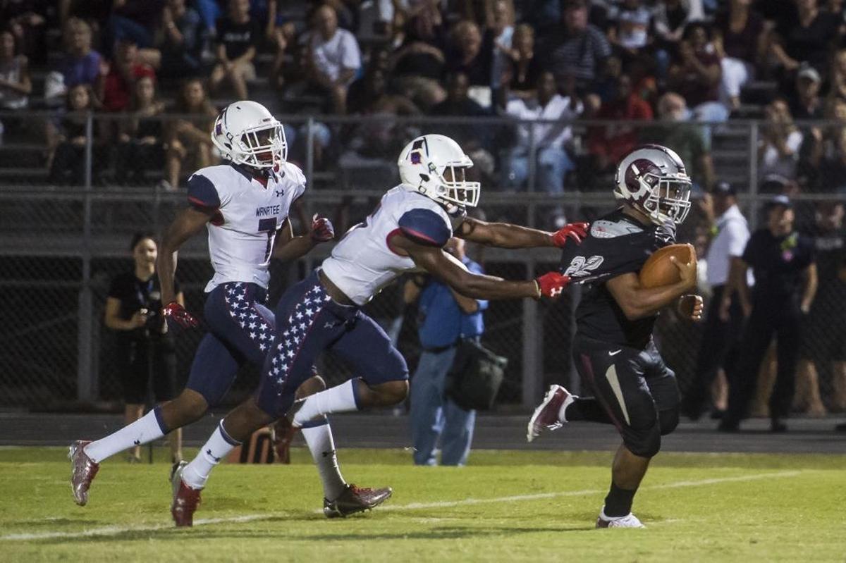 Riverview’s Ali Boyce escapes Manatee defenders to score a touchdown.