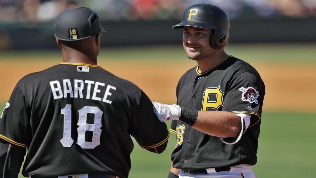 Francisco Cervelli of the Pirates high fives first base coach Kimera Bartee after singling against the Boston Red Sox during a spring training game Saturday in Bradenton.