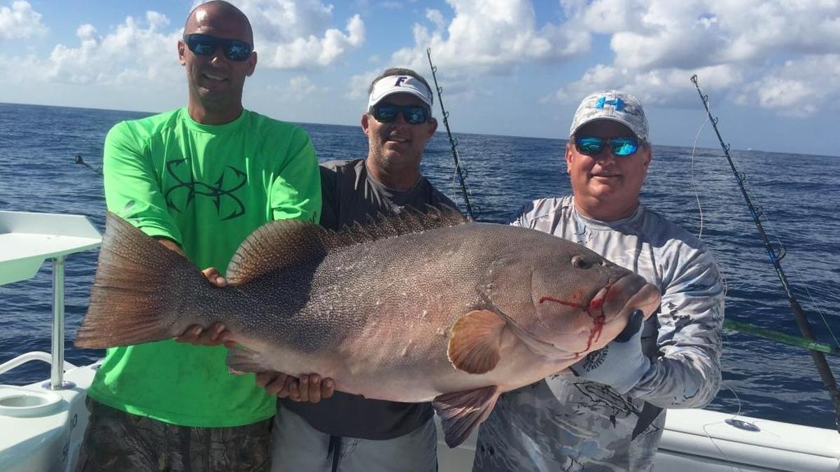 From left: Jim Anderson, Tim Diehl, and Todd Borden hold their 47.8-pound Kitty Mitchell grouper caught during the Fire Charity Tournament for team Haulin’ Grass.