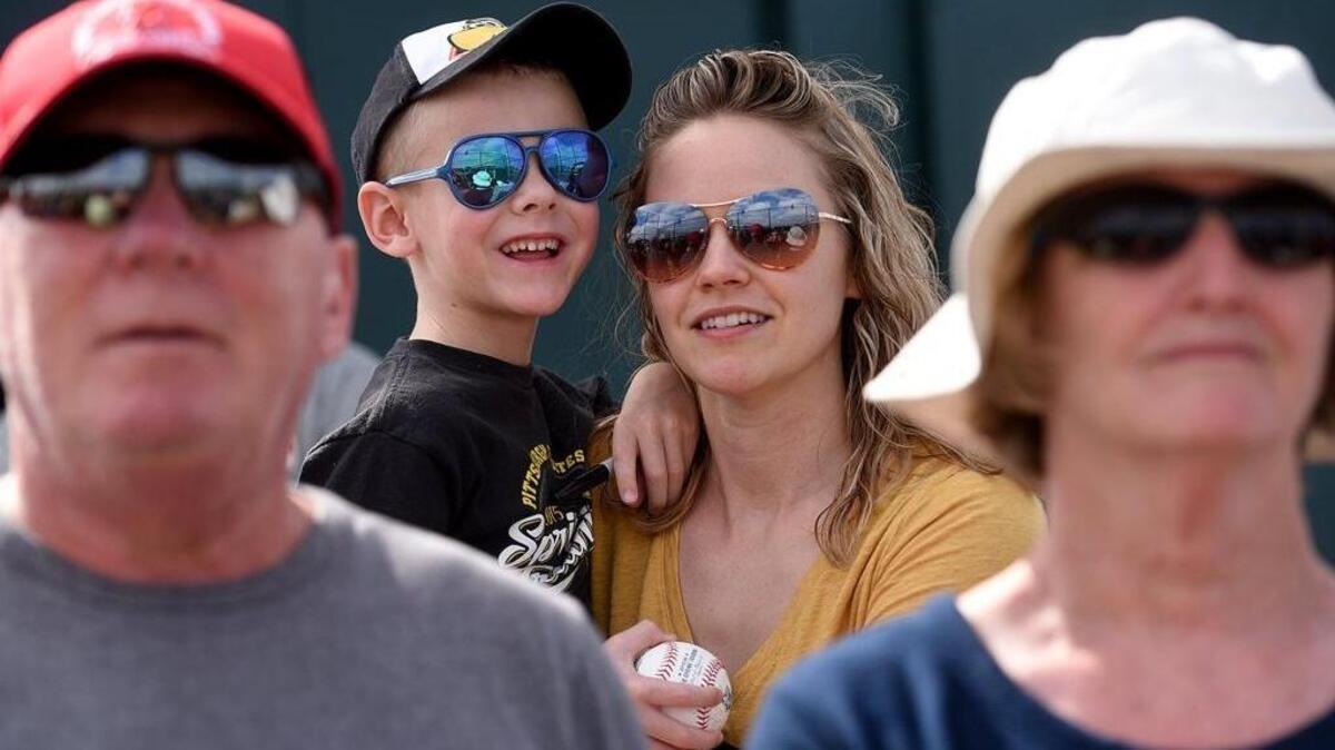 While visiting from Ohio, Landon Pohlman, 5, and his mother, Abby, watch the Pittsburgh Pirates work out on Wednesday at Pirate City in Bradenton.