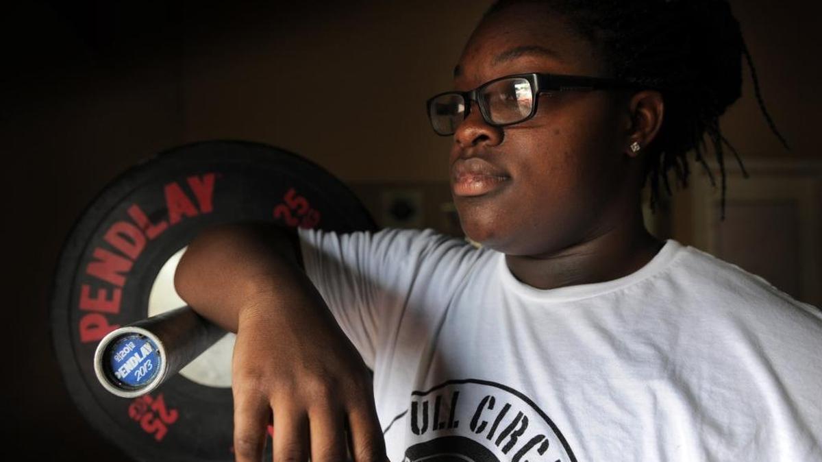 Sha’la McMillan, a record-setting youth lifter, pauses during a training session Friday at City Fitness in Bradenton.