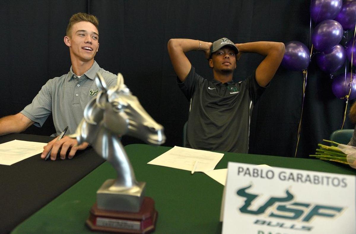 Dylan Buck and Pablo Garabitas relax during signing day at Lakewood Ranch High on Wednesday.