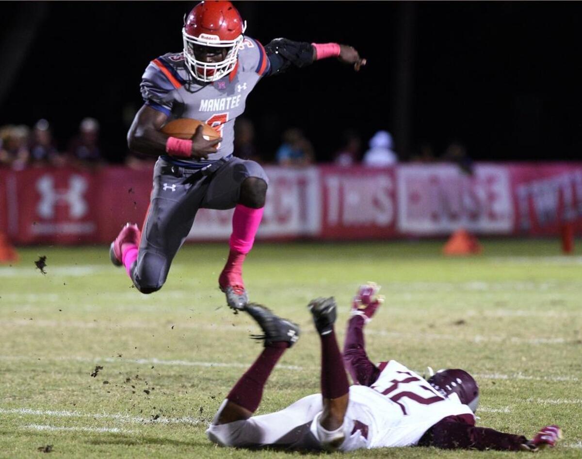 Manatee’s Keyon Fordham leaps over Sarasota Riverview’s Vincent Sellers in last year’s game. Fordham rolled his ankle on the play and didn’t return. The Hurricanes and Rams meet in Sarasota on Friday in an expected district championship game.